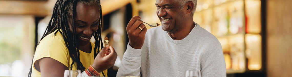 A couple laughing together at a café.