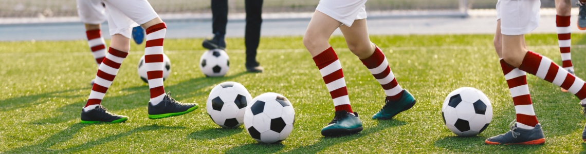 A children’s football coach watching a training session.