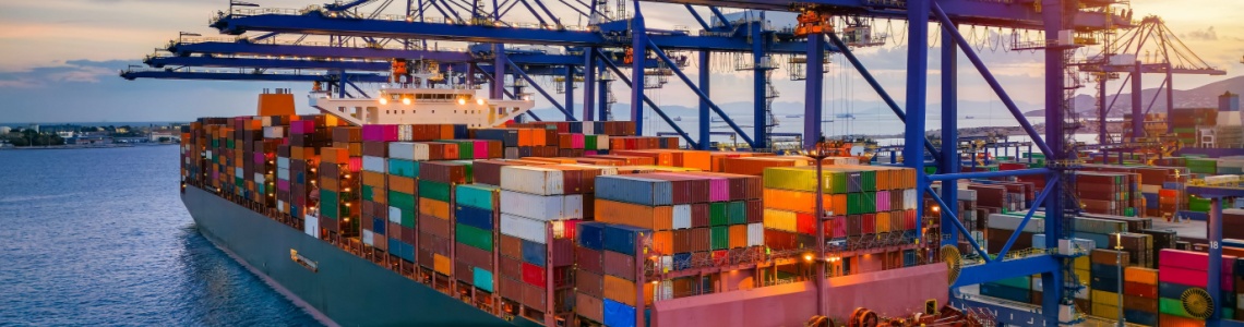 A container cargo ship at a commercial dock.