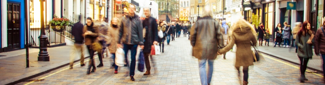 People walking down a high street.