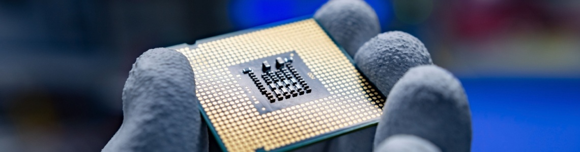 A hand holding a CPU.