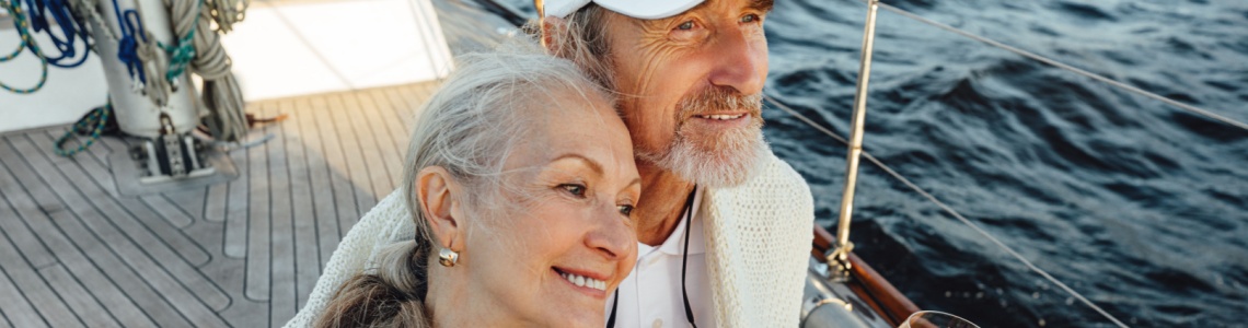 A couple sitting on a yacht deck.
