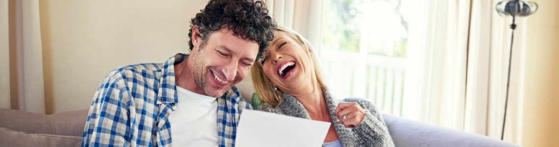 A happy couple reviewing paperwork.