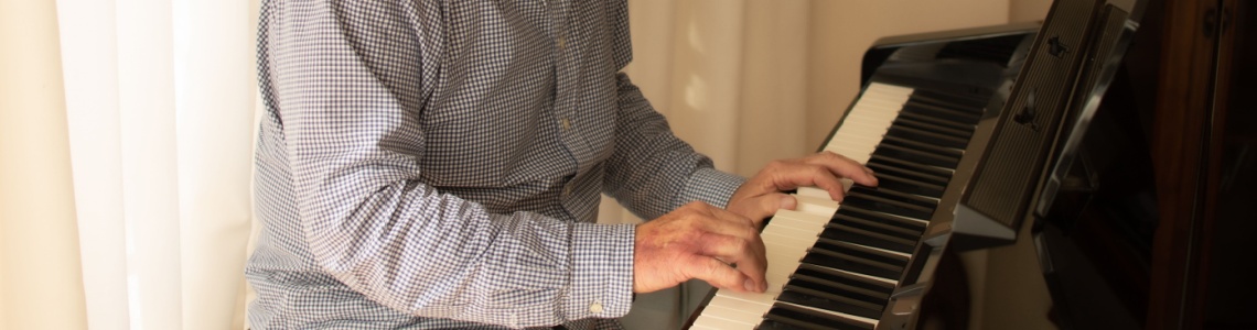 A man practising playing the piano.