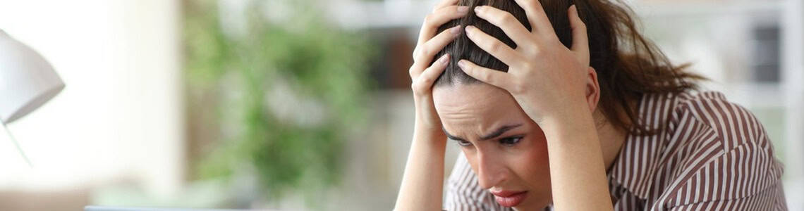 A woman with her head in her hands.