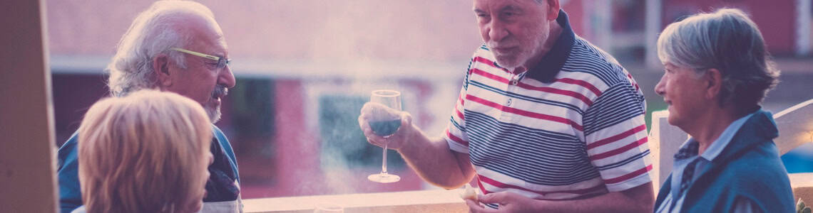 A group of people taking and drinking wine.
