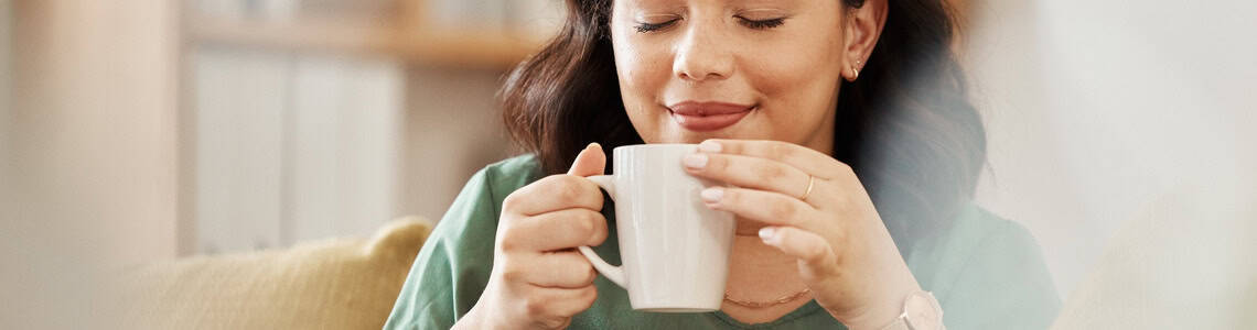 A woman enjoying a quiet cup of tea.